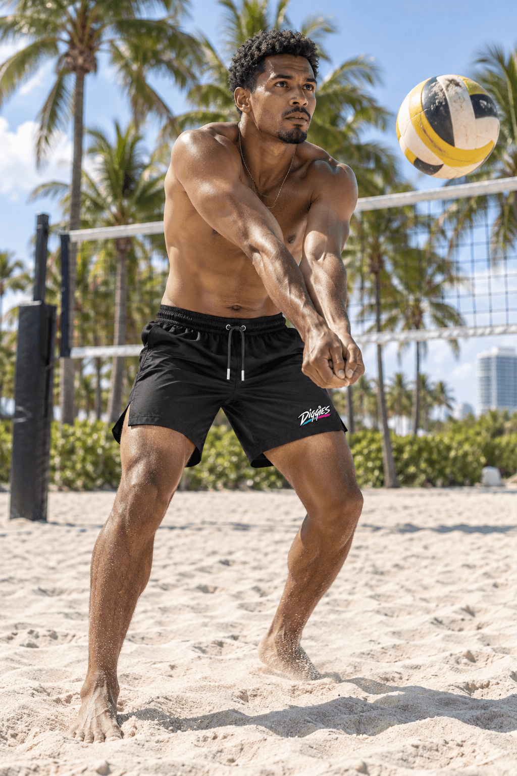 Volleyball player wearing Diggies black shorts on a sand court